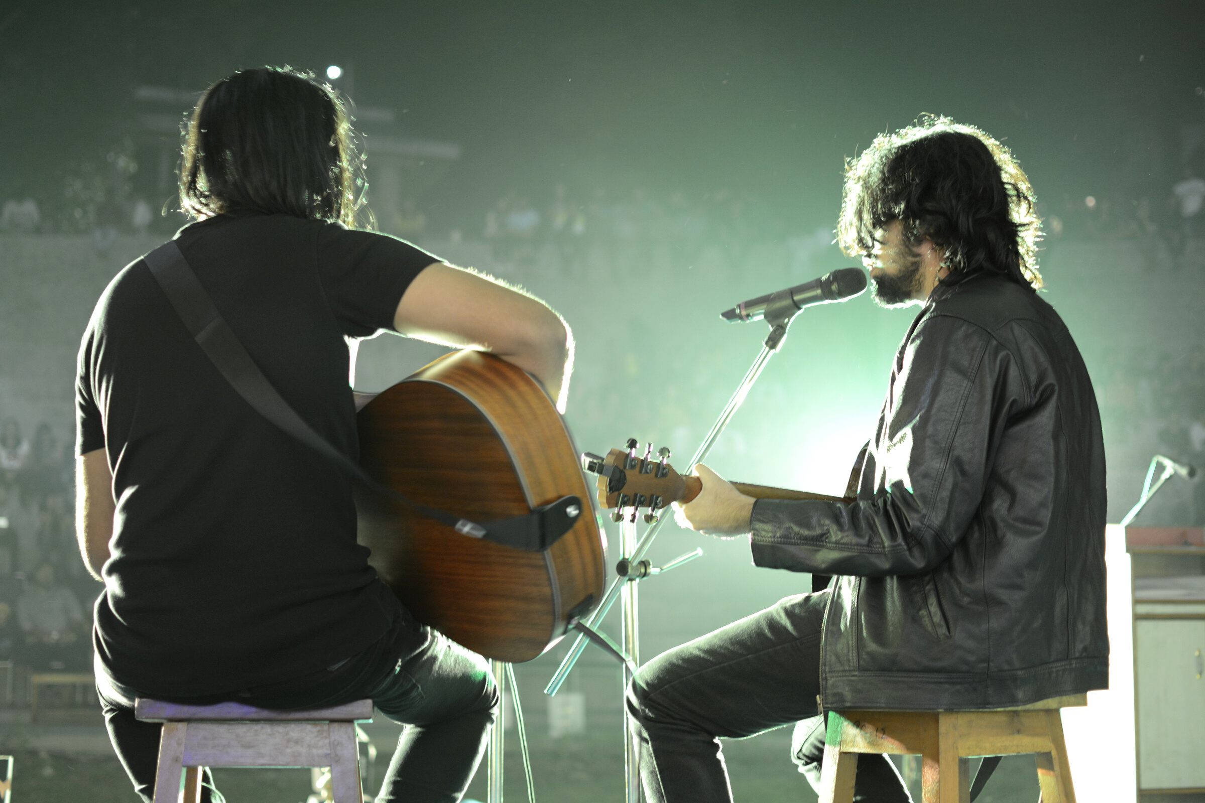 Male musicians with guitars performing on concert